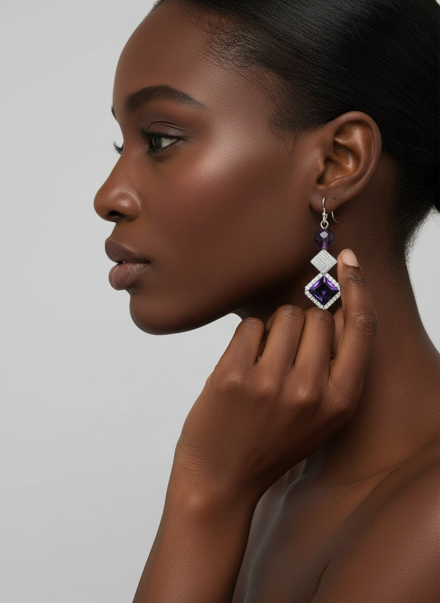 Pair of purple gemstone earrings with silver accents.
