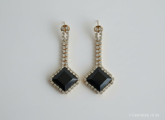  Black square stones and gold accents.